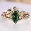 Bridal set with green Dutch marquise diamond and round side stones.