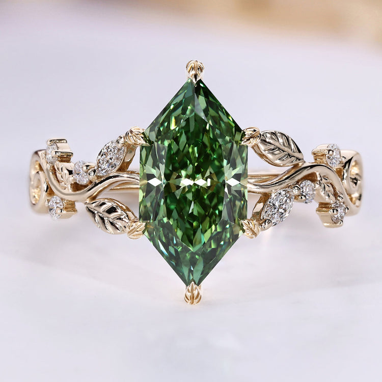 Dutch Marquise ring with green centre diamond and side stones.