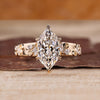 Dutch marquise diamond ring with side stones and tapered shank.