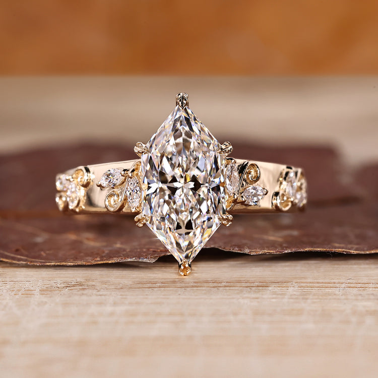Dutch marquise diamond ring with side stones and tapered shank.