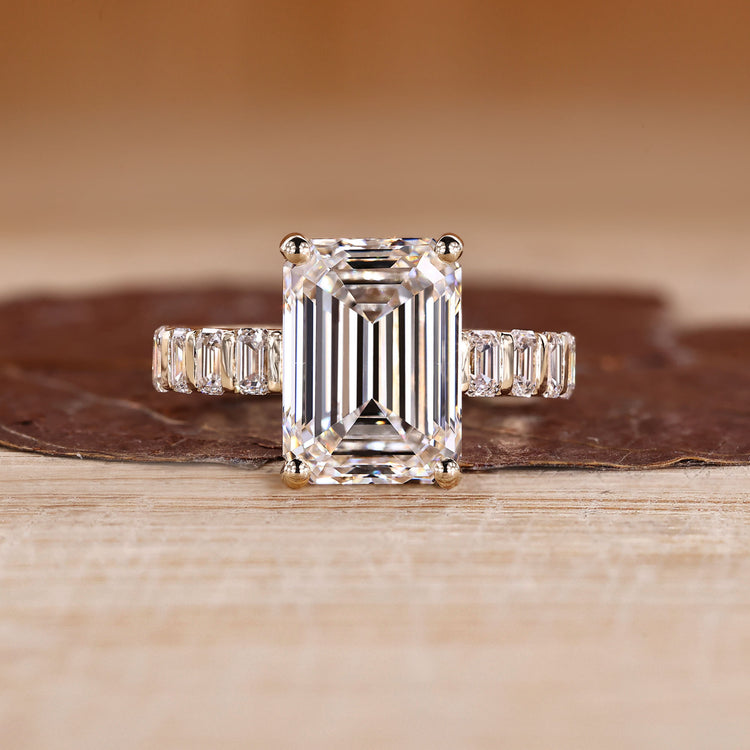 Emerald cut engagement ring with pavé band design.
