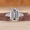 Emerald cut engagement ring with pear side stones.