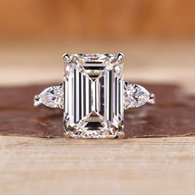 Emerald cut engagement ring with pear side stones.