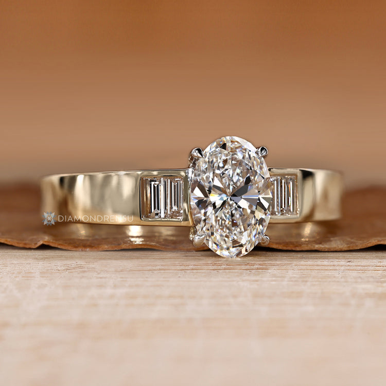 Oval diamond ring with four claw prong setting.