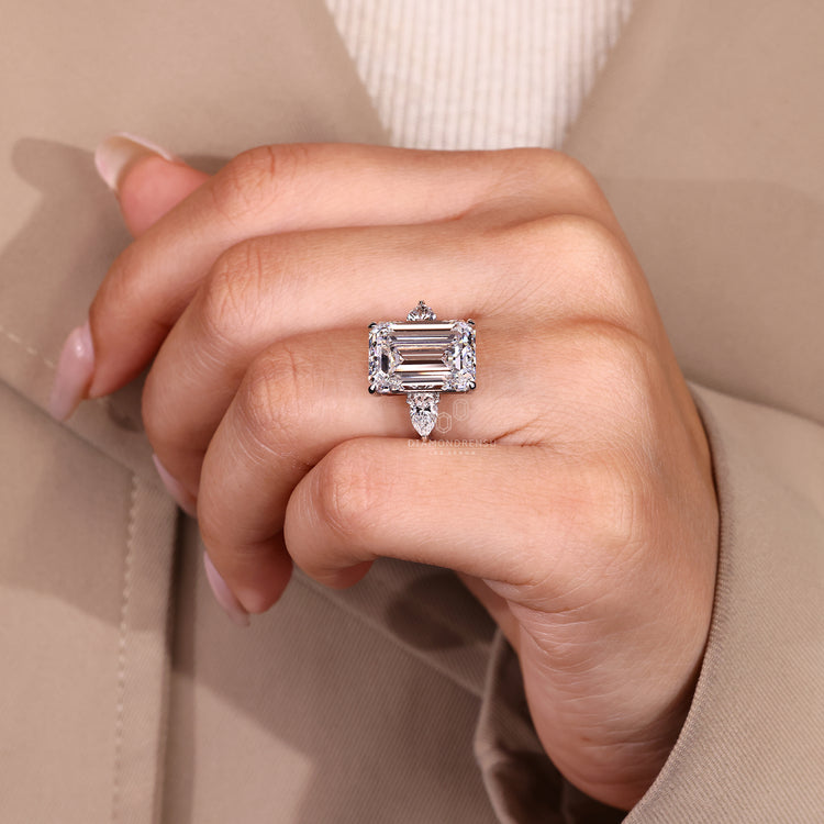 Emerald cut diamond ring with round pave band.