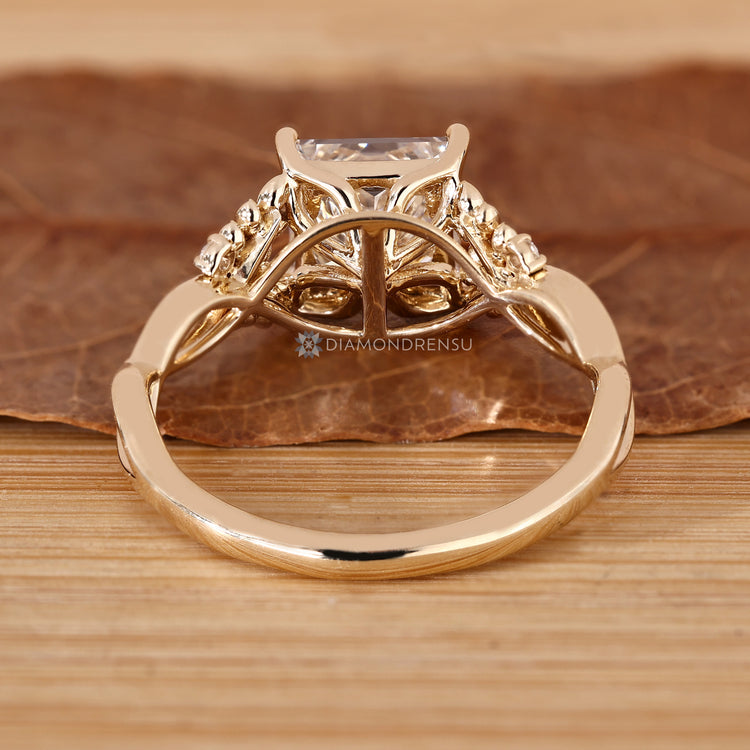 Princess cut engagement ring with tulip setting.