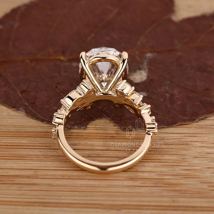 Oval cut diamond ring with basket and cluster setting.