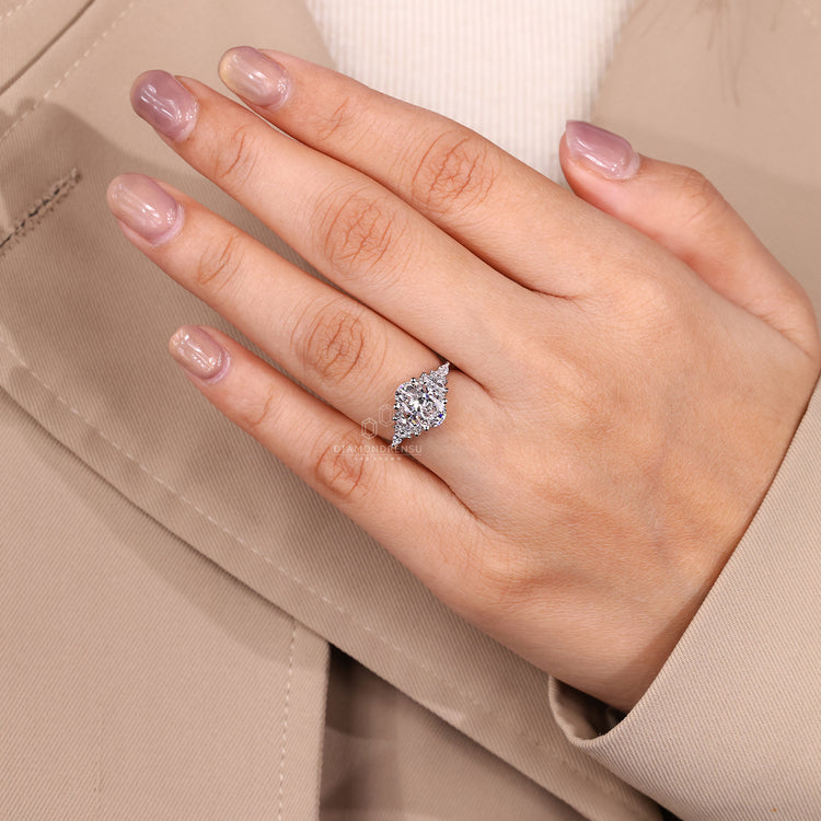 Lab grown oval diamond ring with cluster side stones.