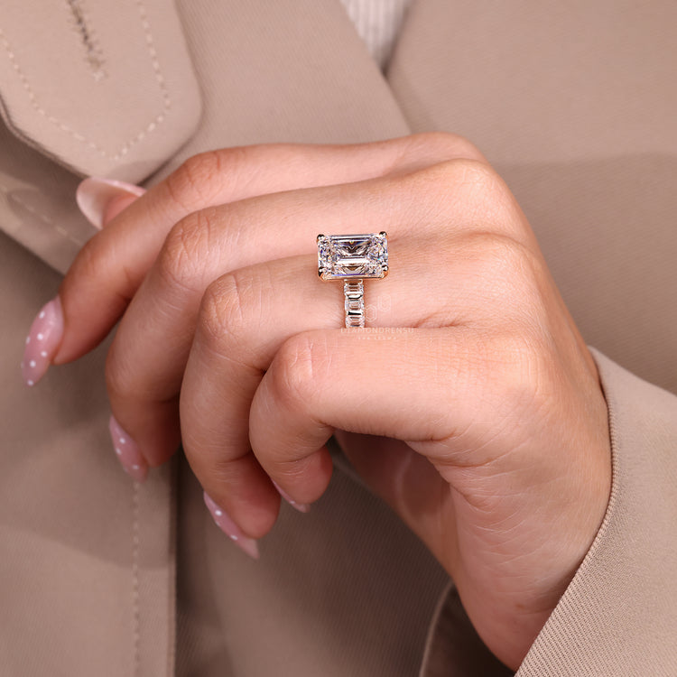 Emerald cut ring with pavé band and prong setting.