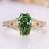 Coffin cut engagement ring with green centre diamond.