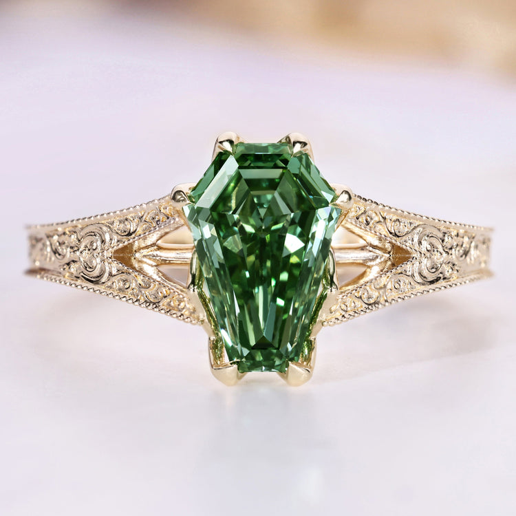Coffin cut engagement ring with green centre diamond.