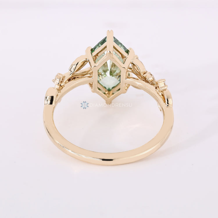 Handmade green diamond ring with round side stones.