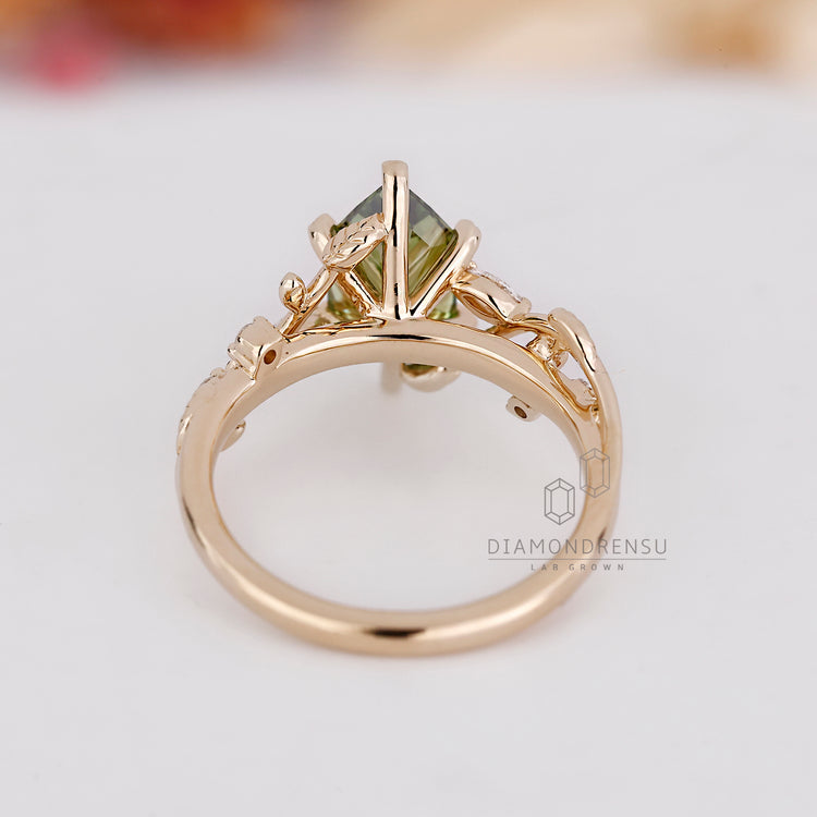 Marquise engagement ring with round stones and leaf prongs.