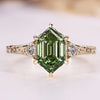 Hexagon cut diamond ring with green centre diamond.