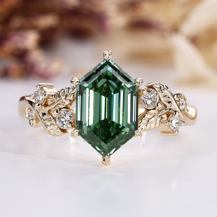 Hexagon cut engagement ring with green centre diamond.