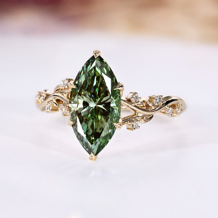 Marquise diamond ring with green diamond and round side stones.
