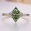 Marquise cut engagement ring with green centre diamond.