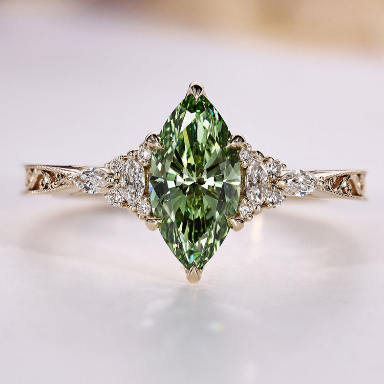Marquise cut engagement ring with green centre diamond.