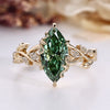 Marquise cut diamond ring with green centre diamond.