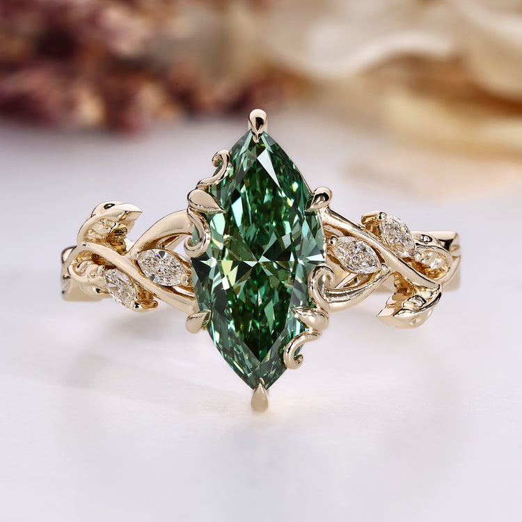 Marquise cut diamond ring with green centre diamond.