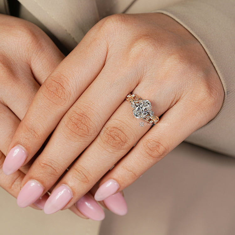 Oval engagement ring with marquise and round side stones.