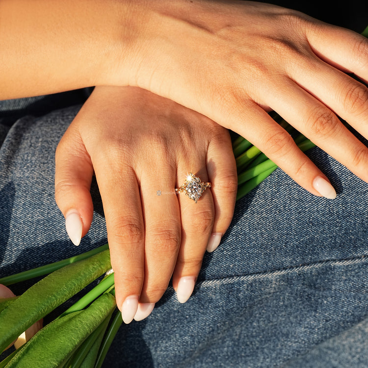 Handmade marquise cut diamond ring with round side stones.