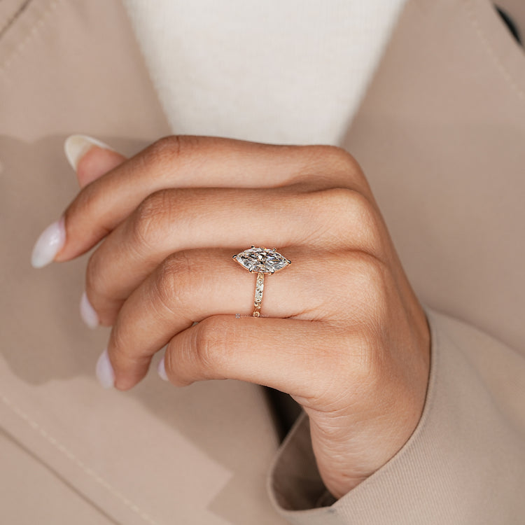 Marquise solitaire ring with floral and leaf shank.