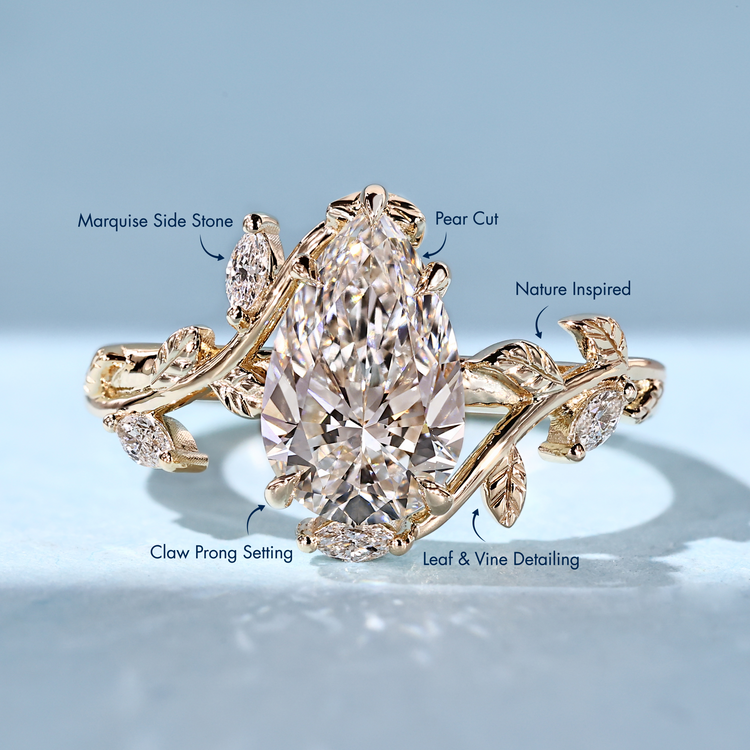 Lab grown pear diamond ring with marquise side stones.