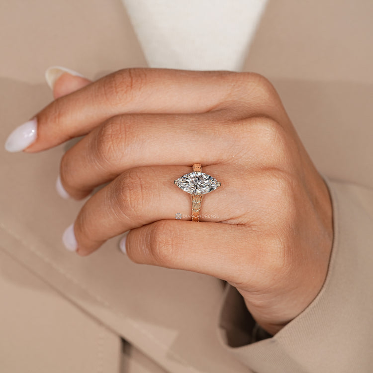 Lab grown marquise diamond ring with fishtail prongs.