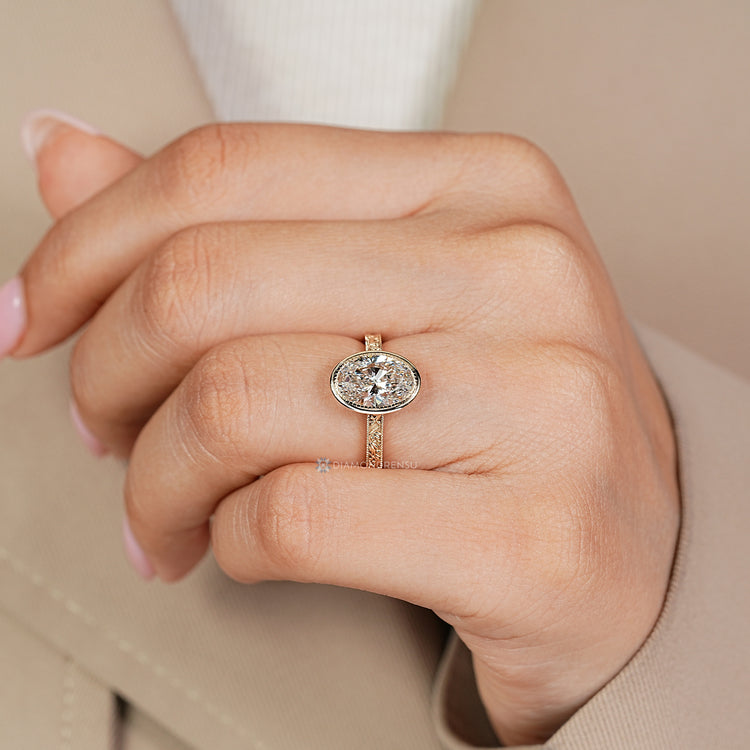 Art deco oval diamond ring with milgrain details.