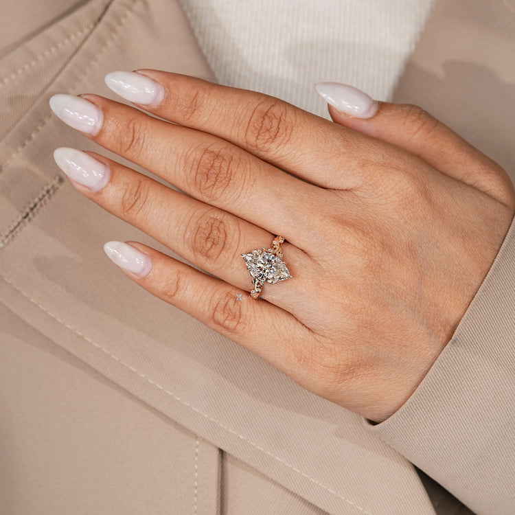 IGI certified marquise cut diamond ring with side stones.