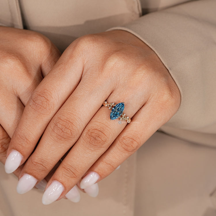 Blue centre marquise ring with six leaf prong setting