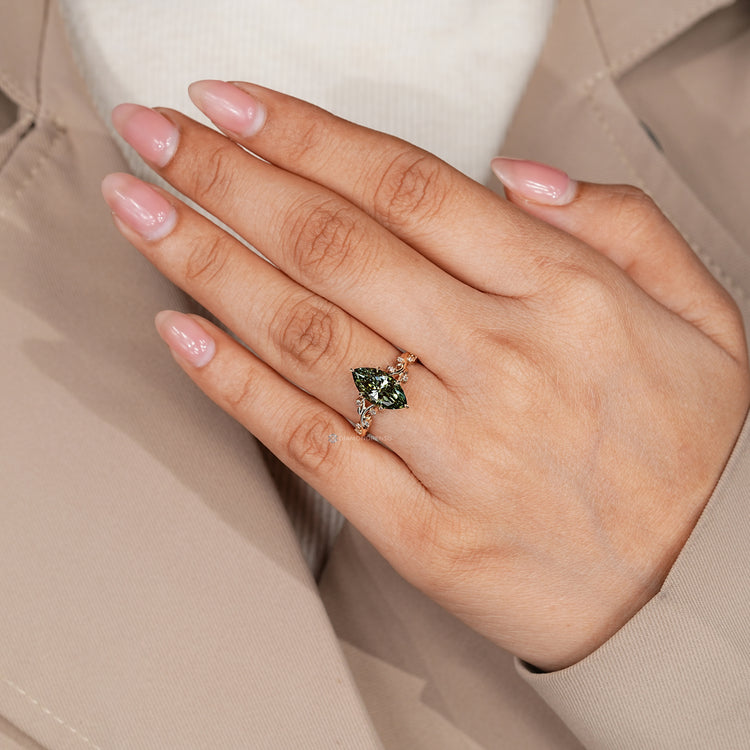 Handmade green diamond ring with six leaf prong setting.