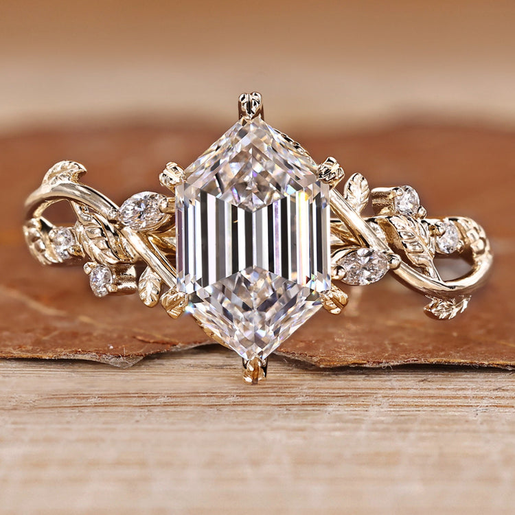Hexagon cut diamond ring with round side stones.