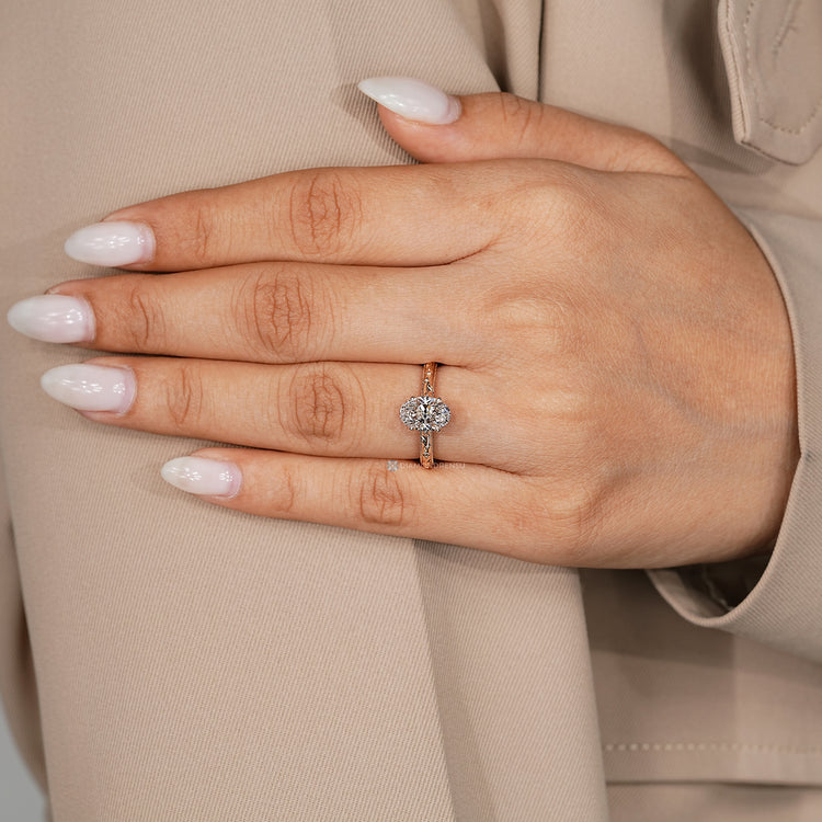 Oval cut diamond ring with four claw prong setting.