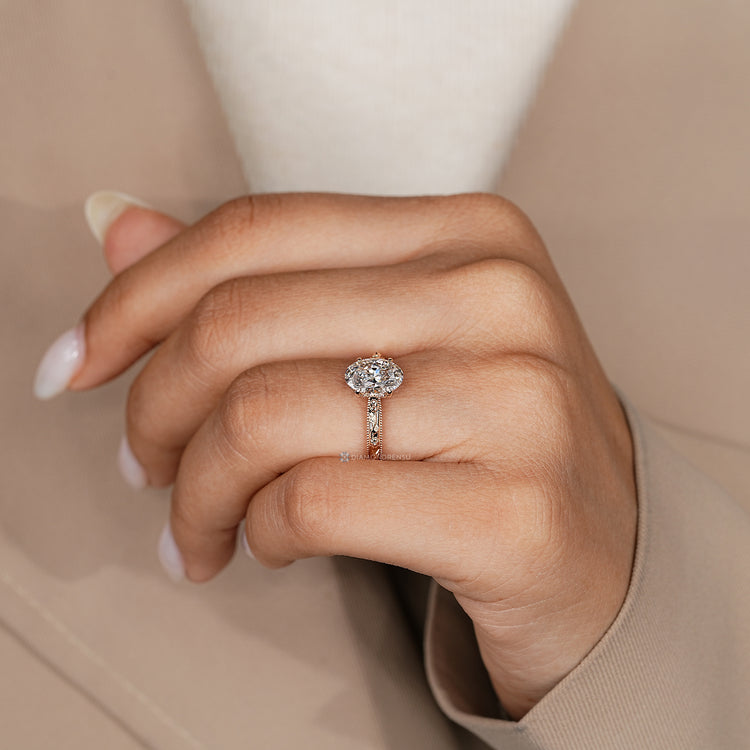 Lab grown oval diamond ring with four claw prongs.