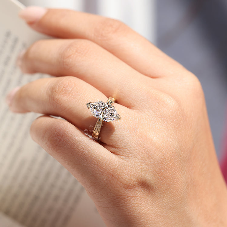 Vintage style marquise diamond ring with V prong setting.