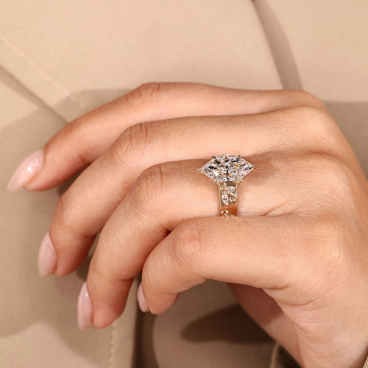 Handmade marquise diamond ring with cathedral setting and leaf prongs.
