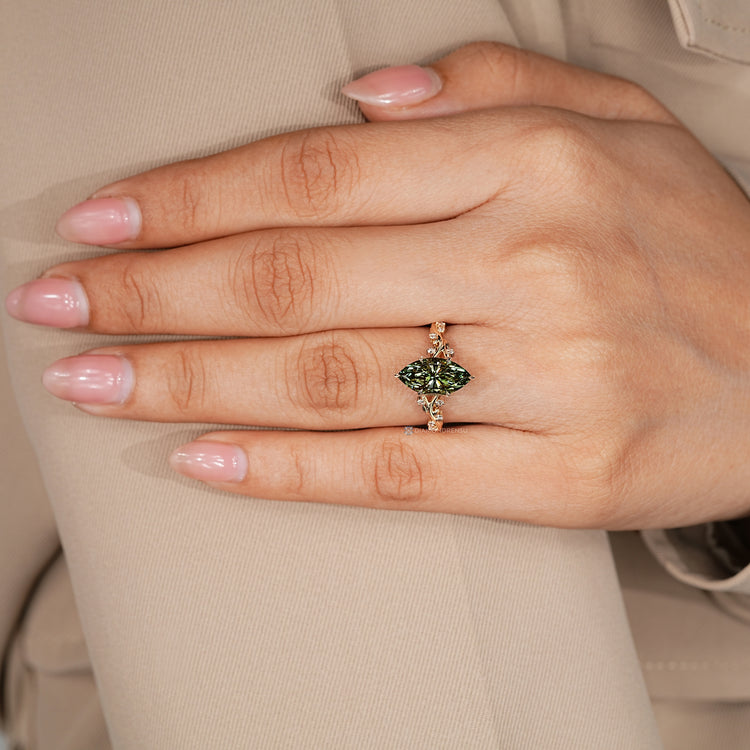Tulip setting marquise ring with round side stones.