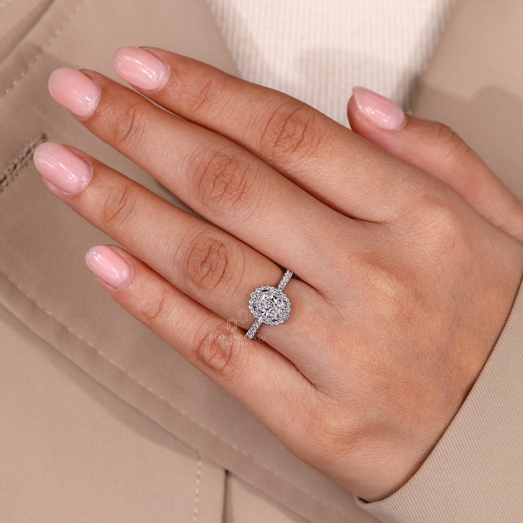Cushion cut diamond ring with round pave and halo.