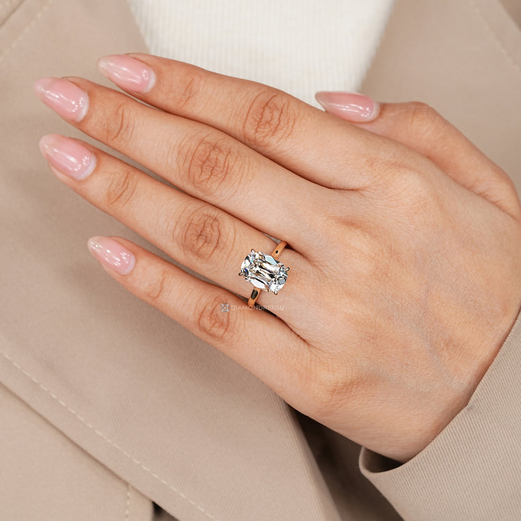 Solitaire engagement ring with a cushion OMC centre diamond.