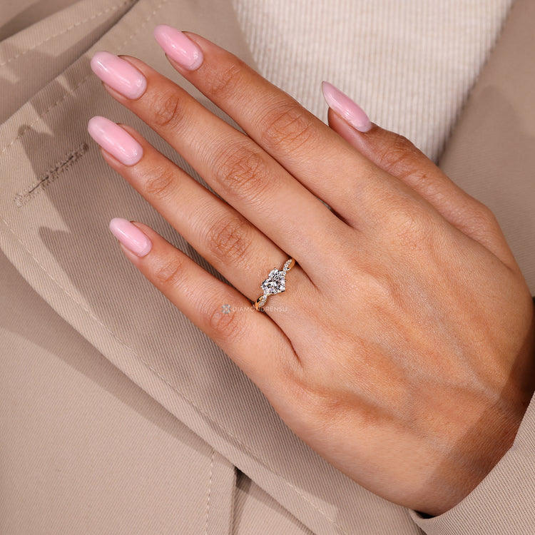 Heart cut engagement ring with round side stones.