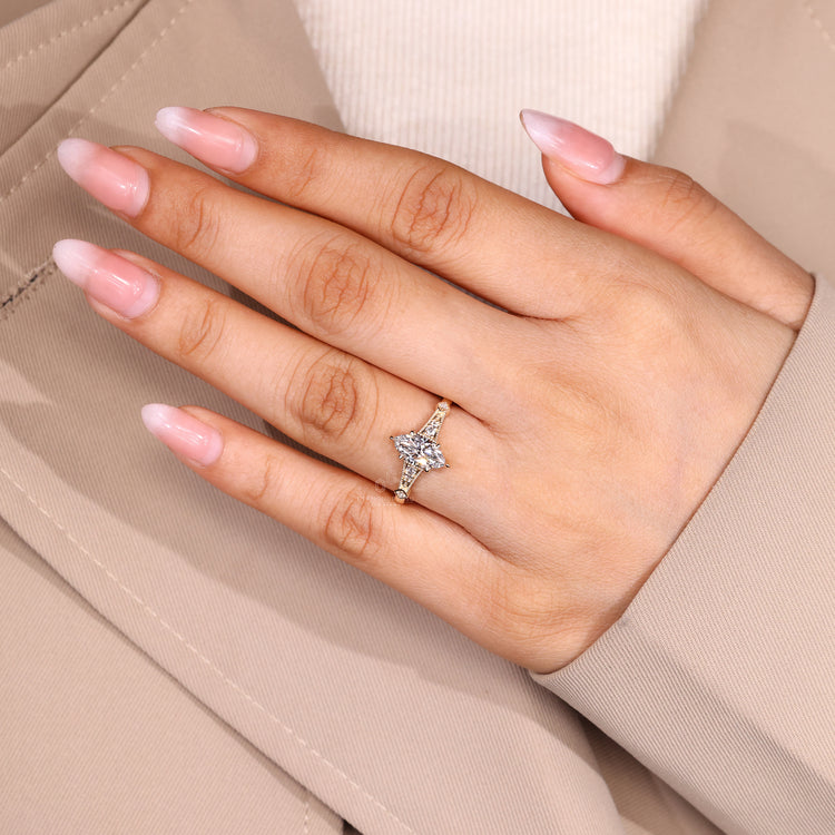 Marquise engagement ring with round side stone accents.