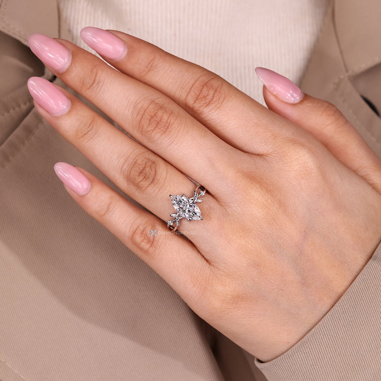 Marquise diamond ring with twisted shank and halo.