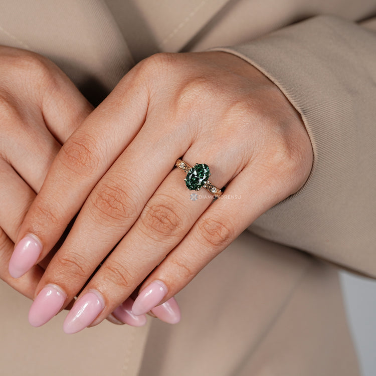Handmade green diamond ring with hidden halo setting.