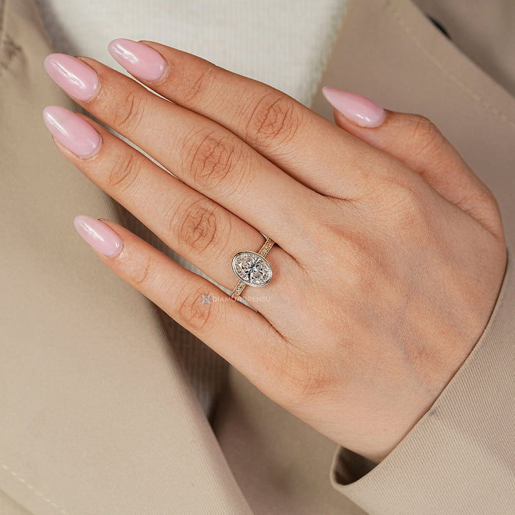 IGI certified oval cut diamond ring with filigree details.