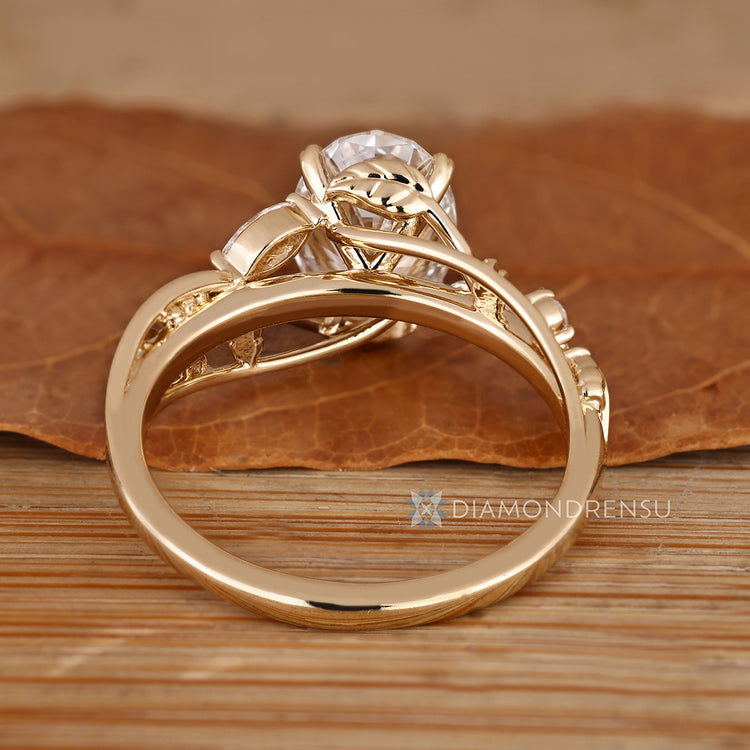 Handmade oval diamond ring with marquise and round stones.