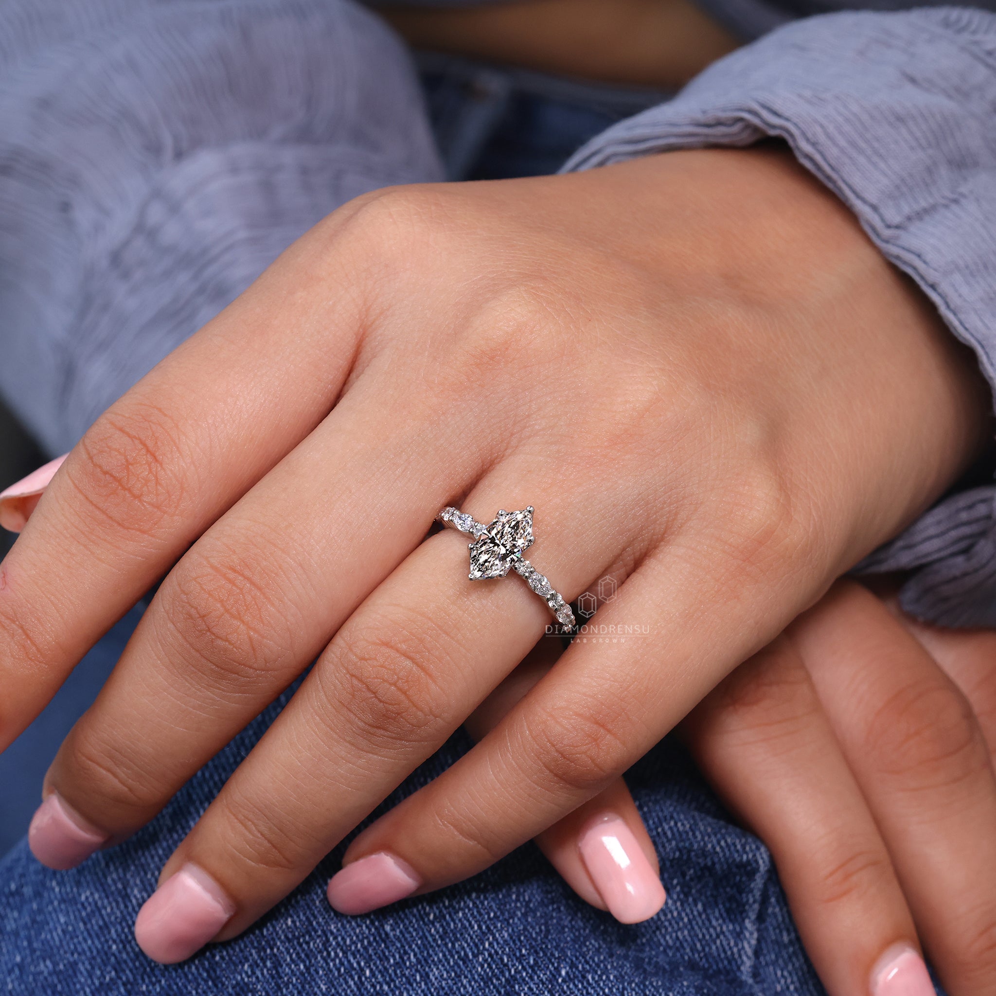 White gold ring with marquise and round diamonds.
