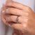 Round cut hidden halo ring with twisted setting.
