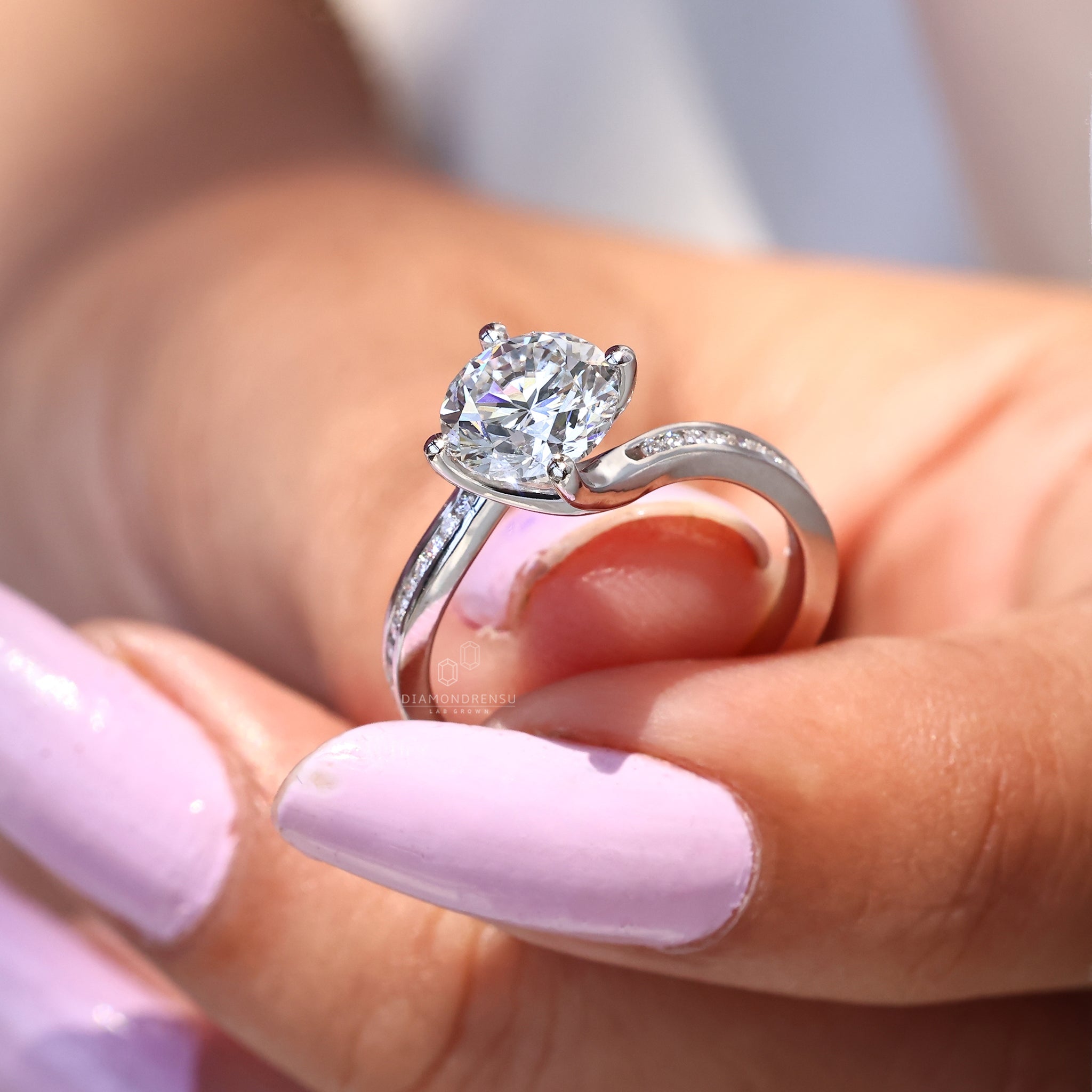 White gold engagement ring with compass prong setting.